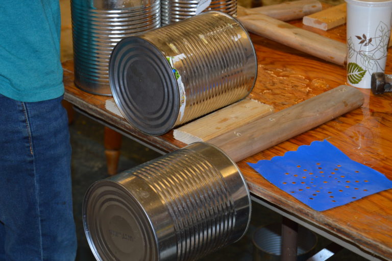 Decorated tin cans on a worktable