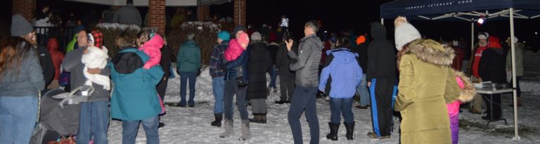 A group gathered outdoors at night
